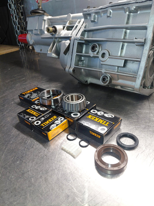 T5 World Class minor rebuild kit with genuine Timken bearings, seals and shift fork pads beside a T5 gearbox